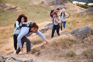 Group of hikers on a grassy hill.