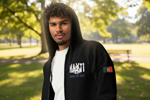 Person wearing a black hoodie with visible branding in a park setting